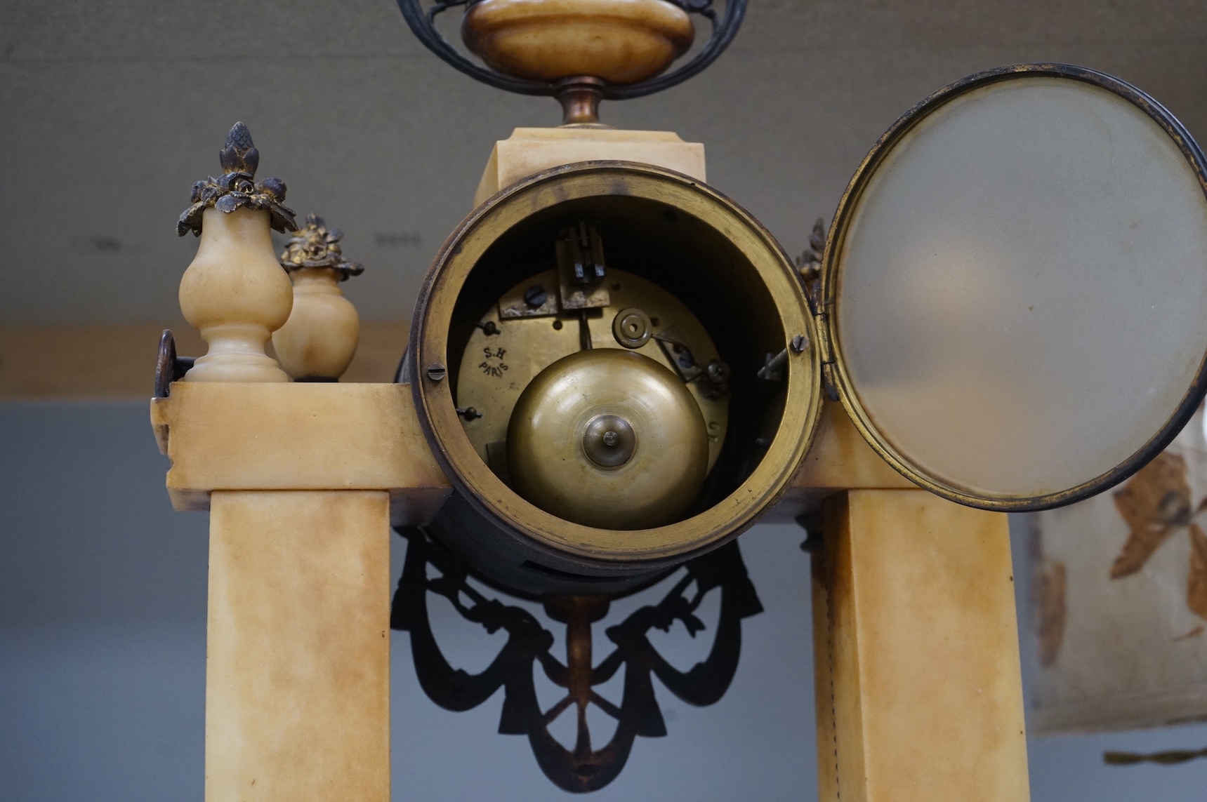 A French gilt metal and alabaster mantel clock, striking on a bell, with pendulum, 49cm high